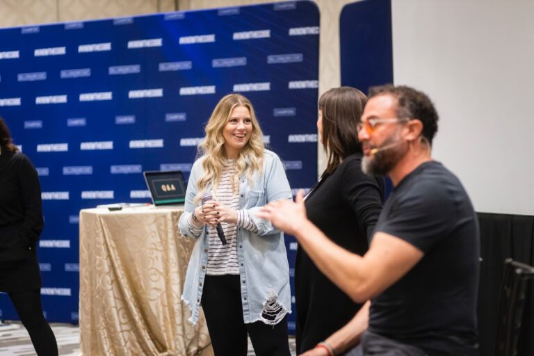 Business operator in discussion with business owner at an event.